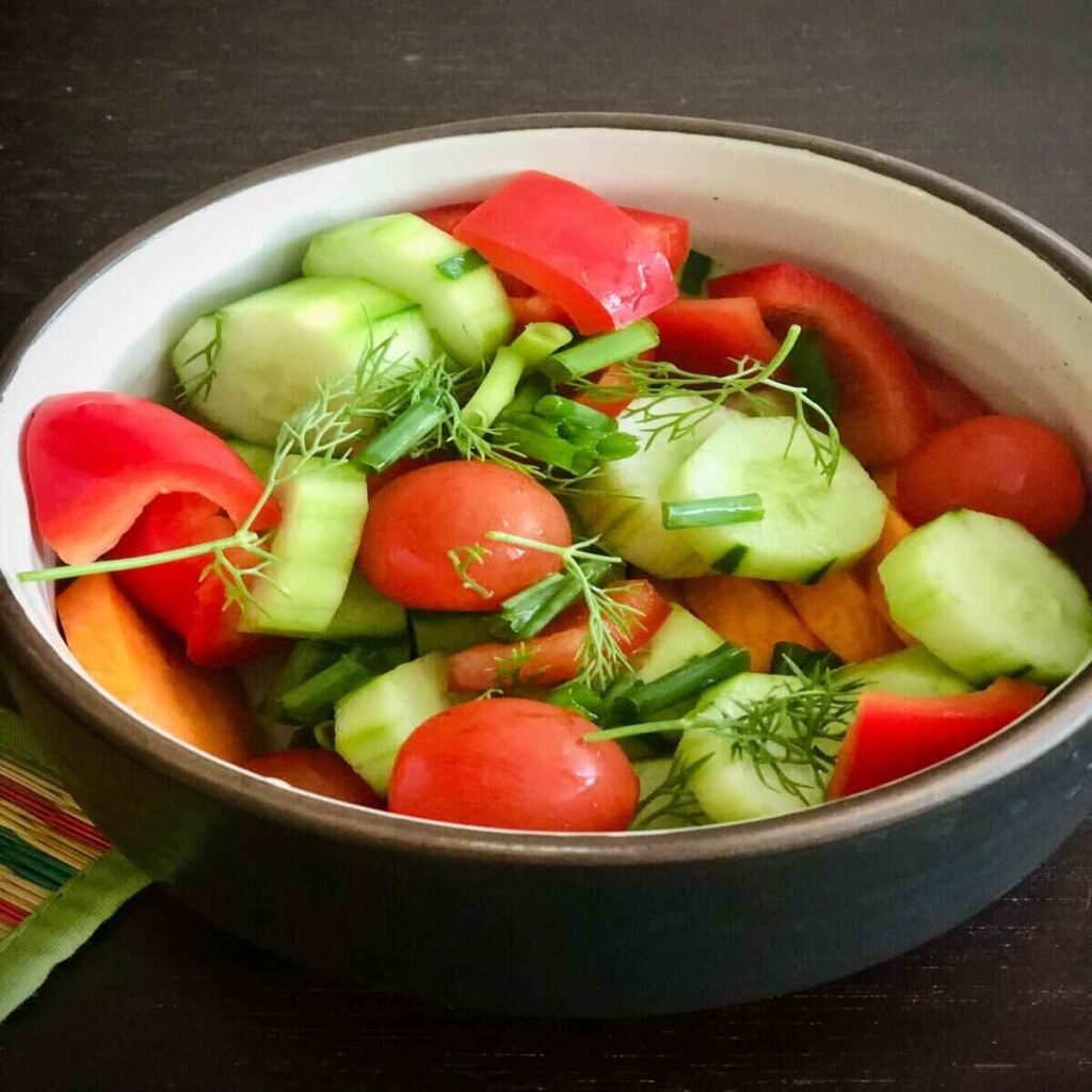 A bowl of Vegetable with Cucumber and Tomatoes